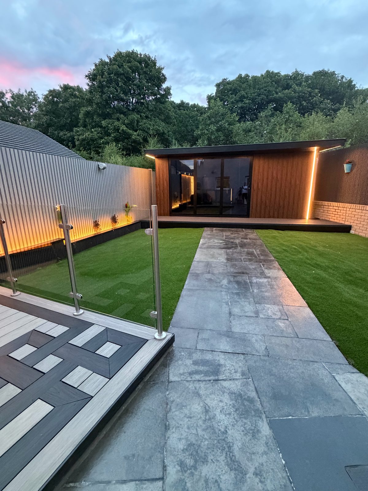 Lit timber garden room with glass doors at dusk — built by EscapeHaus Joinery