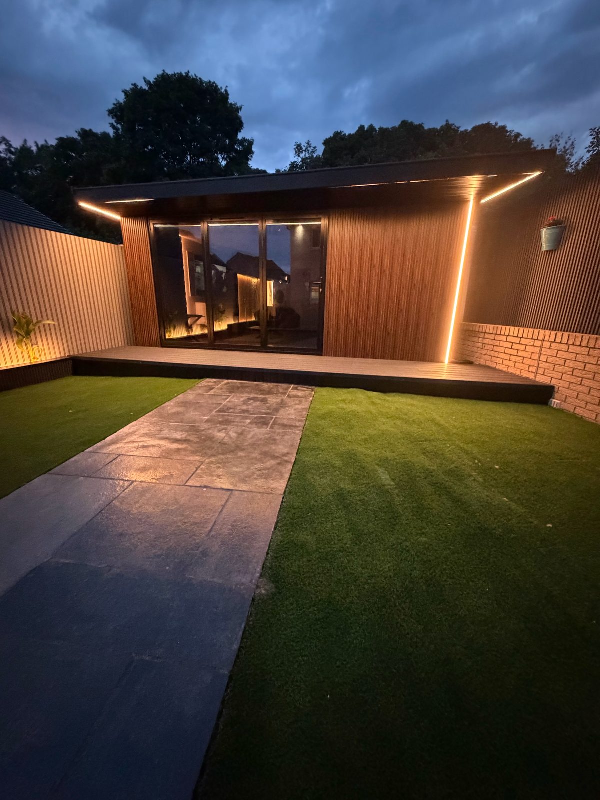 Timber garden room porch with strip lighting at night
