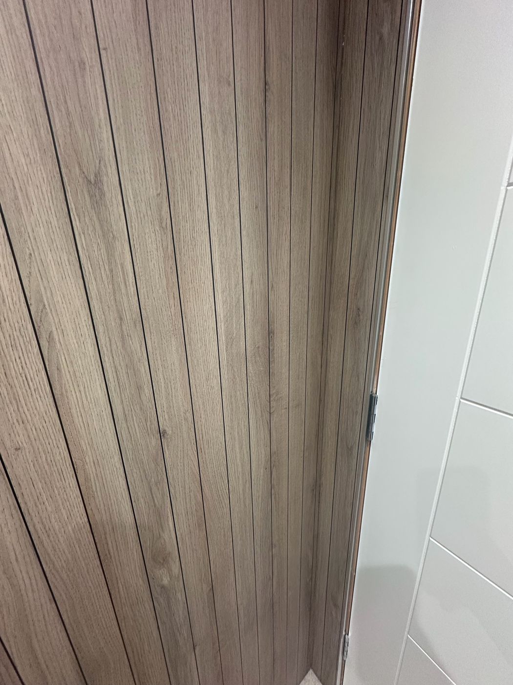 Vertical oak slat joinery paneling and door detail