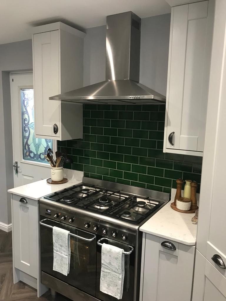 Range cooker with forest-green subway tile splashback