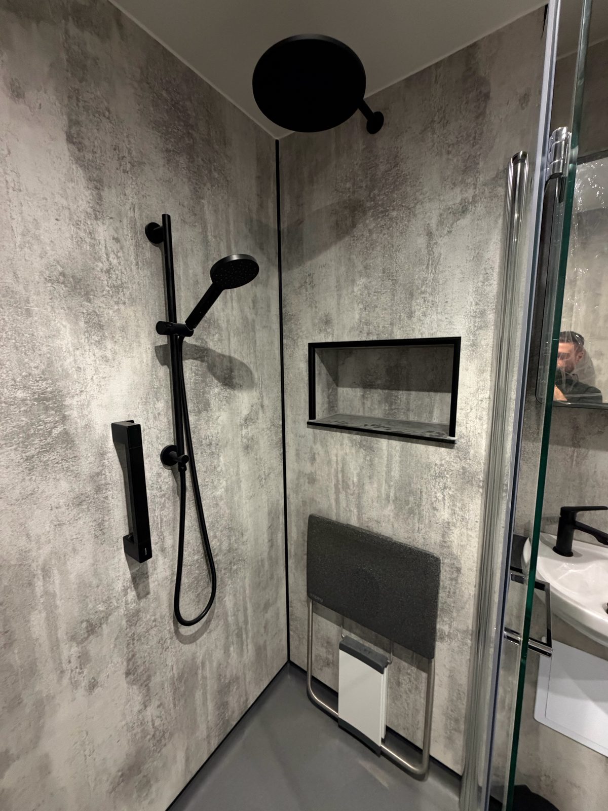 Wet room rainfall shower with tiled niche and fold-down seat